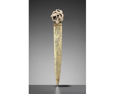 A CELADON JADE 'CHILONG' ORNAMENT, YUAN TO MING DYNASTYChina, 1279-1644. The jade finely carved in openwork as a coiled chilo