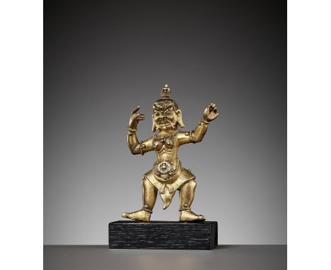 AN INSCRIBED GILT-BRONZE FIGURE OF A DAKINI, 17TH - 18TH CENTURYTibetan-Chinese. The wrathful deity striding in alidhasana, t