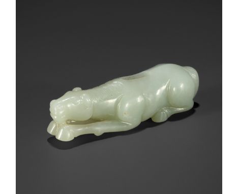 A PALE CELADON JADE 'HORSE' CARVING, 18TH - 19TH CENTURYChina. Carved in a recumbent pose, the head resting on the outstretch