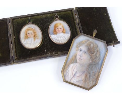 A pair of Victorian miniature watercolours on ivory, portraits of young girls, unsigned, with hair inset glass backs in 9ct g