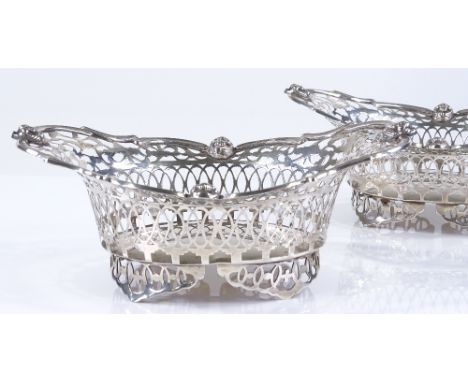 A pair of Edwardian silver bon bon baskets, with pierced surround, and small cast cherub handles, by Sibray, Hall &amp; Co Lt