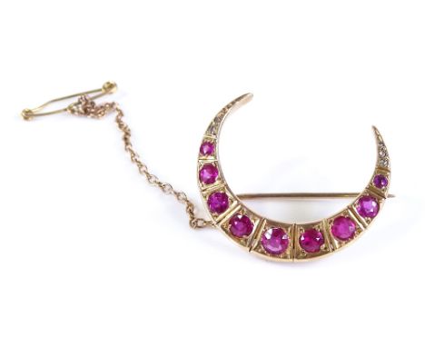 A Victorian ruby and diamond graduated crescent brooch, unmarked gold settings, length 28.8mm, 4.6g 