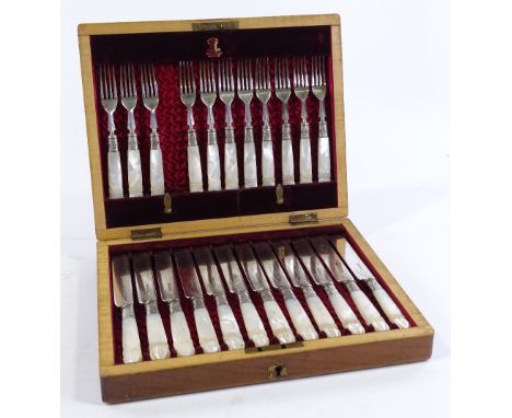 A cased set of Victorian carved mother-of-pearl handled dessert knives and forks for 12 people (missing 1 fork), with plated 