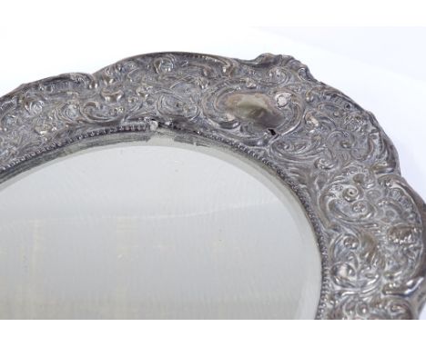 An Edwardian silver-fronted photo frame, with all over relief embossed foliate and scrollwork designs, by Henry Matthews, hal