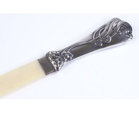 An unmarked silver-handled ivory page turner, with relief floral Art Nouveau style handle, overall length 34cm 