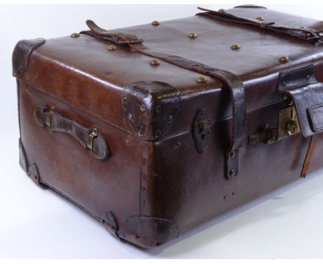 A large brown leather travelling trunk with brass studs, 82cm x 47cm x 34cm 