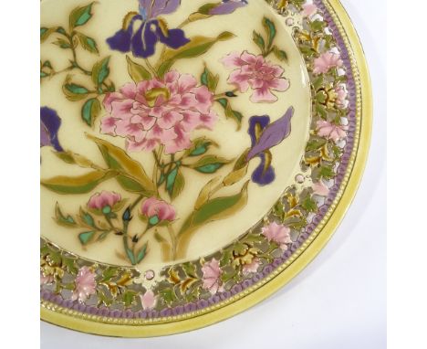 A Zsolnay Pecs ceramic charger, with pierced floral decorated border and hand painted iris design centre panel, pattern no. 3
