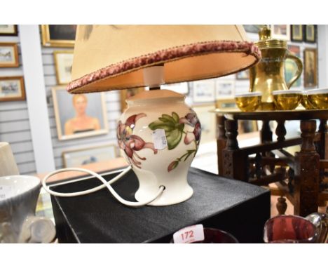 A modern Moorcroft pottery 'columbine' pattern table lamp, tube lined with flowers against a cream ground, the shade decorate
