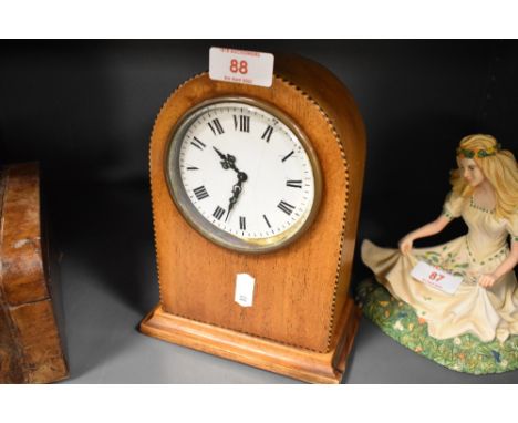 An Edwardian inlaid-mahogany mantel clock, of arched form, with Roman hours to the enamelled dial