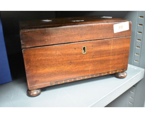 A 19th century mahogany twin compartment tea caddy, of plain rectangular form, the base with inlaid chain link band, on bun f