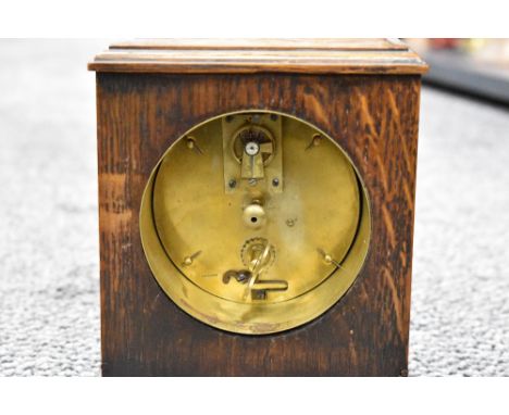 An early 20th century oak mantel clock, with Arabic hours to dial, the brass movement marked 'France'