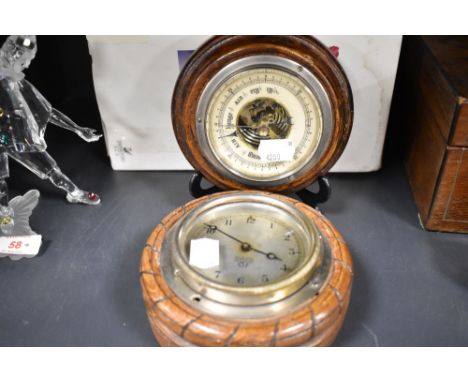 An early - mid 20th century oak framed Smiths clock sold with a barometer of similar form.