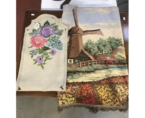 An embroidered chair back cover and a small Dutch windmill scene tapestry.
