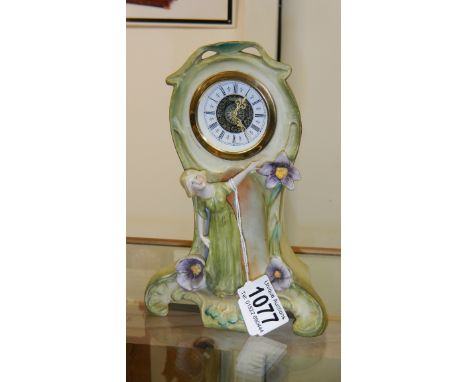 An art nouveau porcelain boudoir clock with figure.