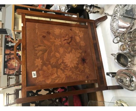 A wooden firescreen with flower pattern.