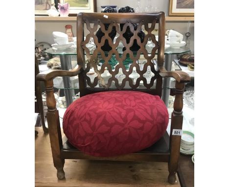 A child's armchair with pouffe seat.