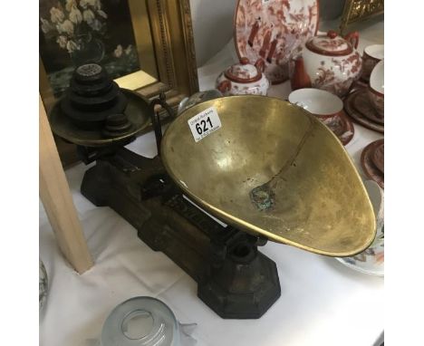 A set of vintage cast iron scales with brass pans including weights.