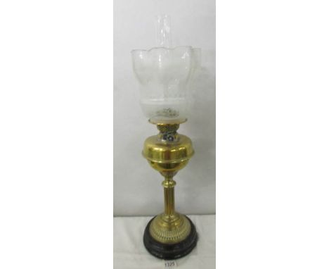 A Victorian brass column oil lamp with original acid etched tulip shade.  (slight nibble to rim).