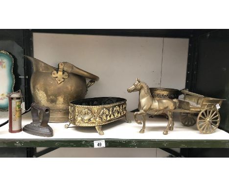 A shelf of brassware including horse and cart, coal scuttle etc.