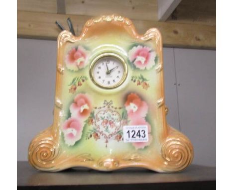 A pottery mantel clock with battery movement.