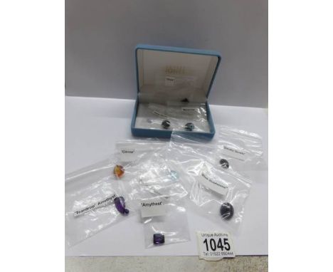 13 loose gemstones including 6.9ct blue topaz, pear amethyst 12.5cts, Citrine 12cts, emerald, amethyst 7cts and 9 other stone