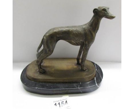 A bronze greyhound on a marble base.