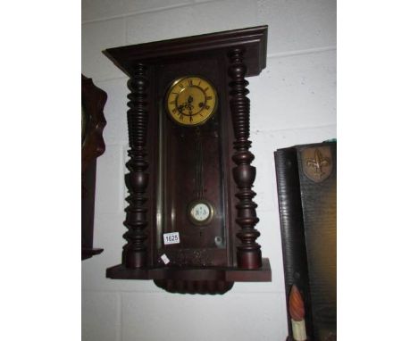 A mahogany wall clock.