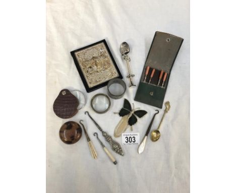 A mixed lot of metal items including button hooks, a spoon, napkin ring etc.