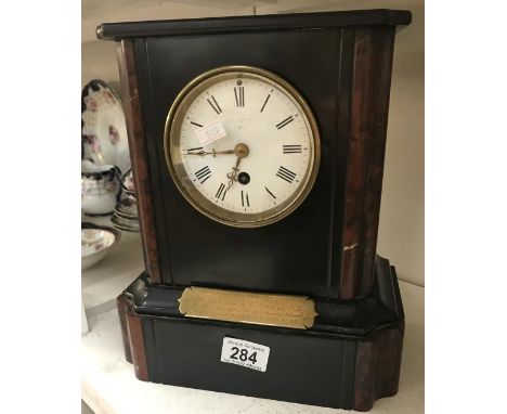 A black slate mantle clock.