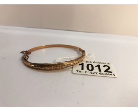 A 9ct gold bangle with safety chain weight 6 grams and bearing a Birmingham hall mark.