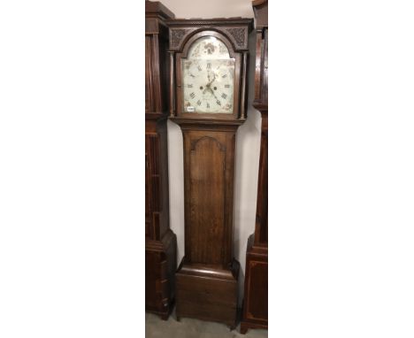 An oak cased 8 day long case clock with painted arched dial, 'Thos. Peasford, Berwick'.