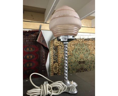 An art deco chrome table lamp with shade.
