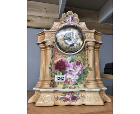 A floral decorated pottery mantel clock.