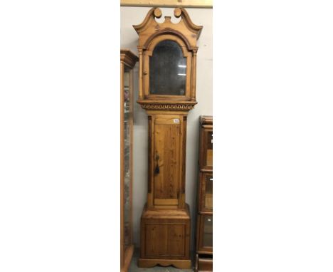 An arched top pine Grandfather clock case.
