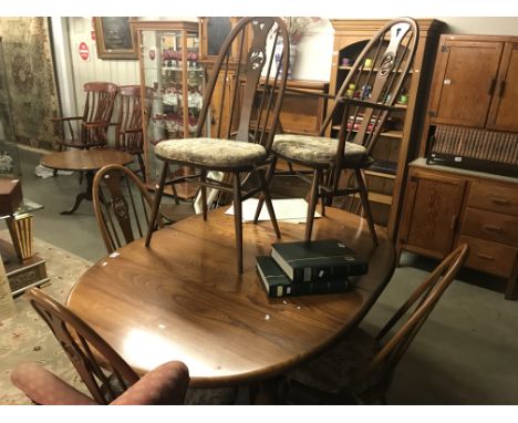 An Ercol dining table and 6 Ercol dining chairs.