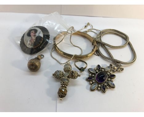 A jet brooch with hand painted porcelain miniature portrait (a/f), a gold plated bangle, a cross pendant on silver chain, an 