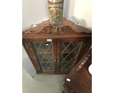 A glazed corner wall shelf cupboard.