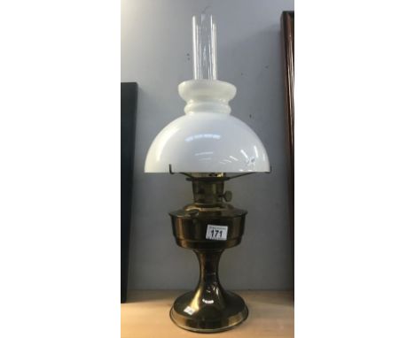 A brass aladdin oil lamp with shade and chimney.