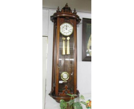 A mahogany double weight wall clock.