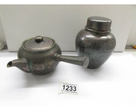 A 1920's Japanese pewter teapot and tea caddy with tea, (caddy is signed).