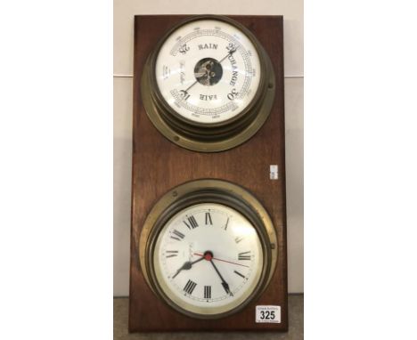 A clock and barometer set on a wooden wall mount.