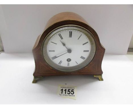 An inlaid mantel clock.