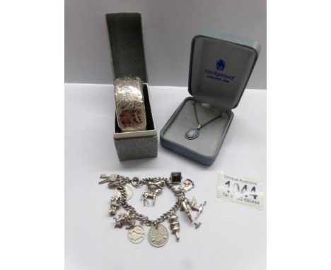 A silver bangle H.M Cohen &amp; Charles, Birmingham 1966 together with a Wedgwood pendant on silver chain and a silver charm 