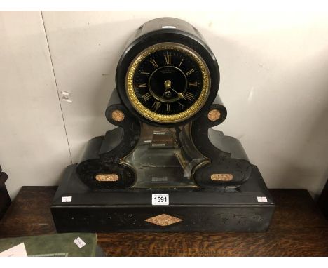 A black marble mantel clock marked J Dusart, Bruxelles.
