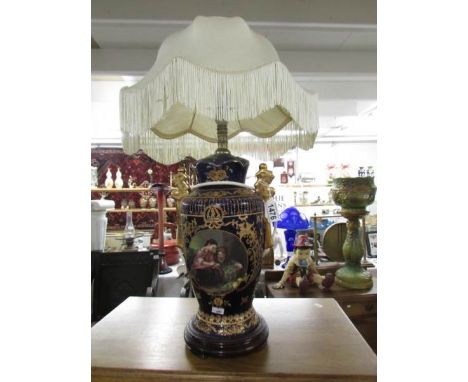 A gilded pottery table lamp with shade.