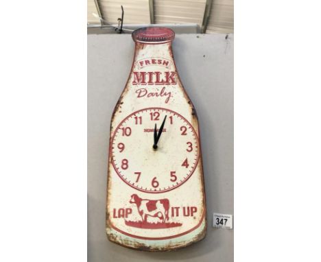 A metal milk bottle advertising sign wall clock.
