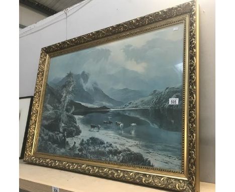 A framed and glazed print of cattle in a mountainous scene.