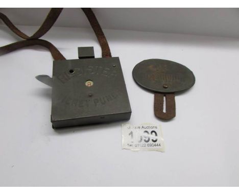 A 1950's toy ticket machine and a toy conductor's badge.