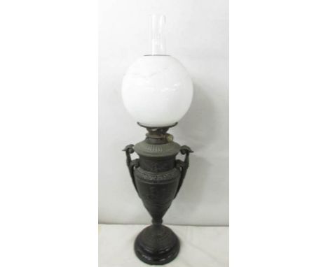 A Victorian Hink's spelter oil lamp in the form of an urn with drop in font and complete with shade and chimney.