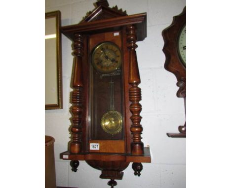 A mahogany wall clock.